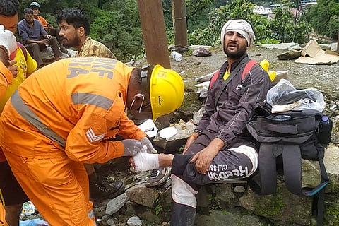 Stranded pilgrims being attended by NDRF men